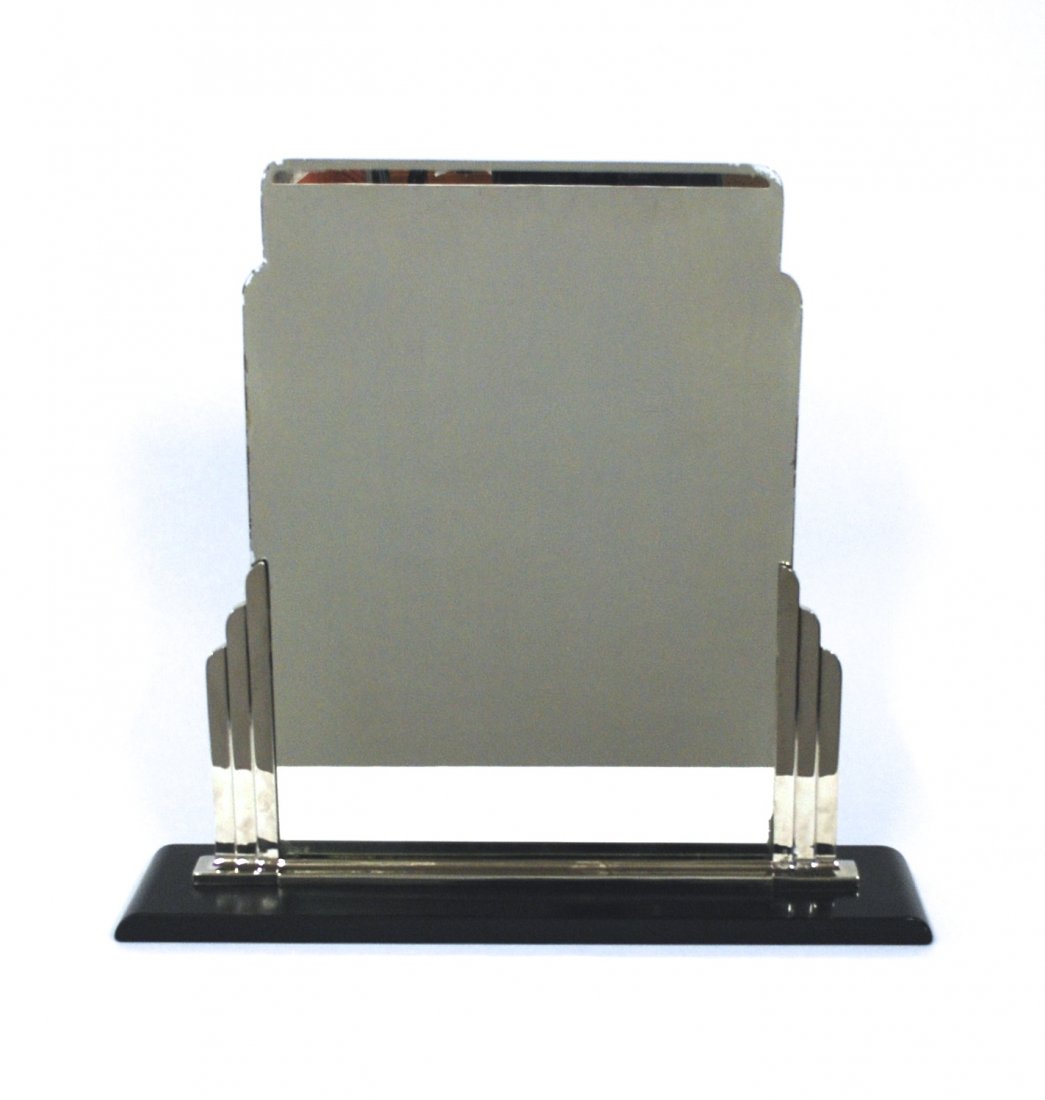Norman Bel Geddes: Art Deco mirror, Simmons, curve base with skyscraper sides. Lacquered metal, aluminum and mirrored glass. Original finish. Size 27.5w x 6.5d x 26h