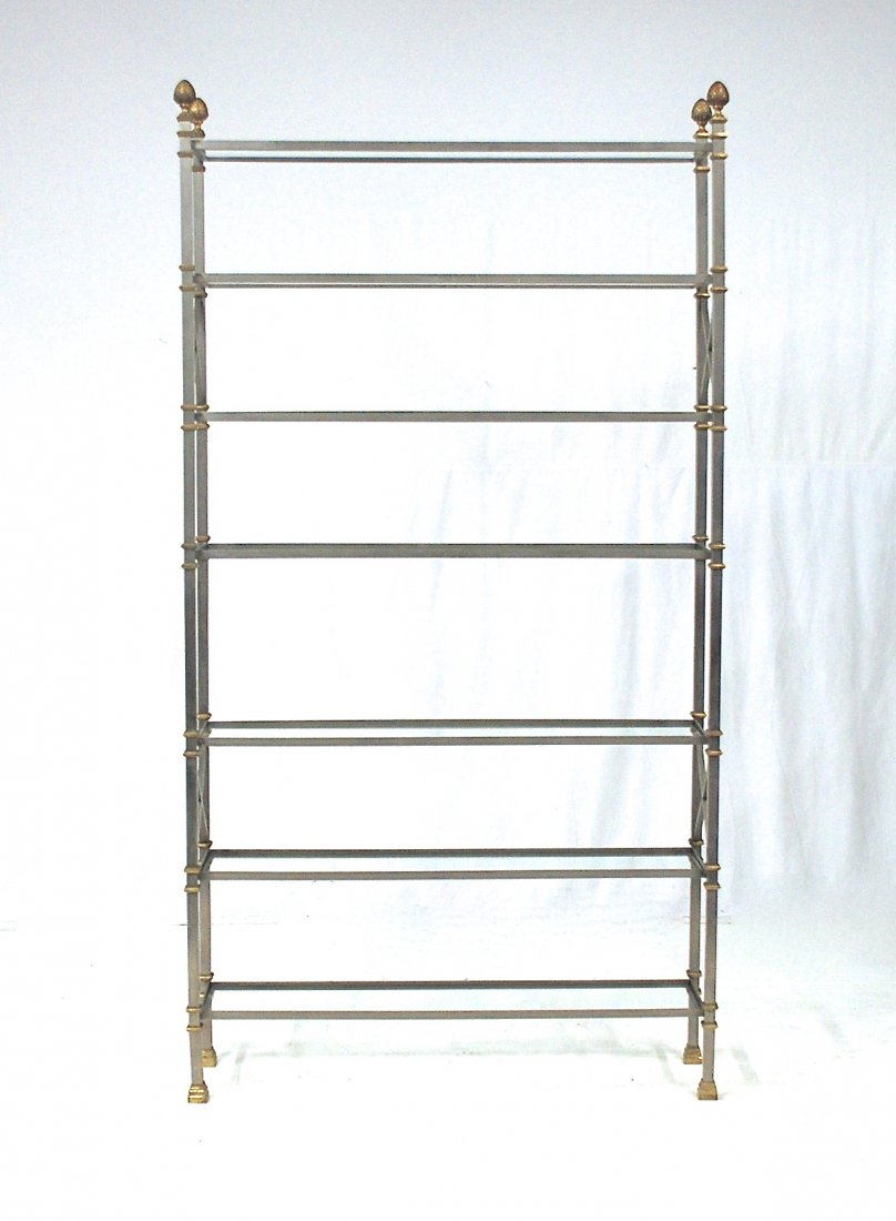 Maison Jansen: Fine stainless steel and brass etagere. Artichoke finials with glass shelves. Same example was sold by Todd Merrill Antiques as Maison Jansen. Companion to Lot# 276. However, slight variation in heigh