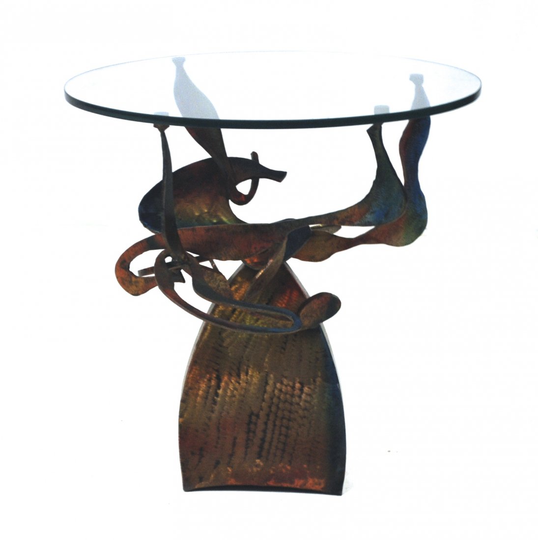 In the Manner of Albert Paley: Free form sculptured metal base with round glass top. 24 x 23.75