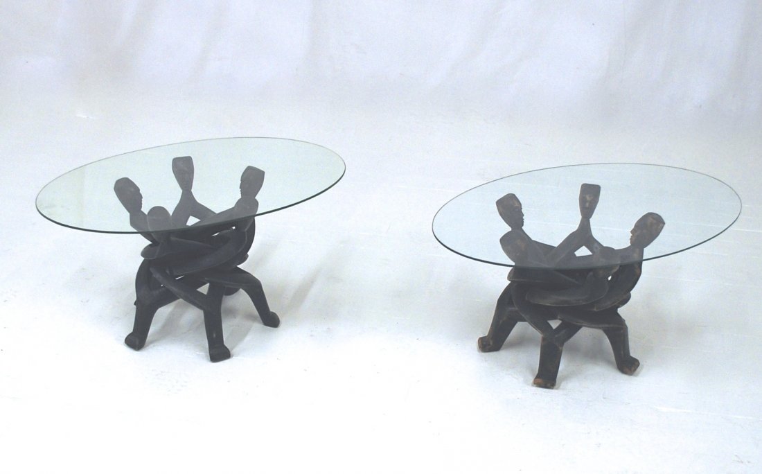 African Mahogany Figural Tables: Pair of glass top occasional tables. Great size. Each table folds for easy shipping. Wear to finish, nice patina. Size 28w x 19d x 15h