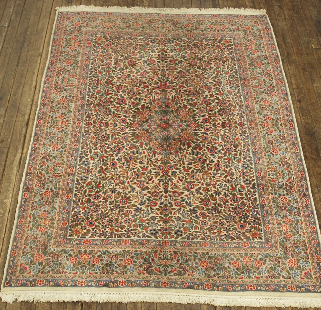 Kerman: Field of rose, blue, beige, floral all over design. 105 x 81. Collection of Tom Powell.