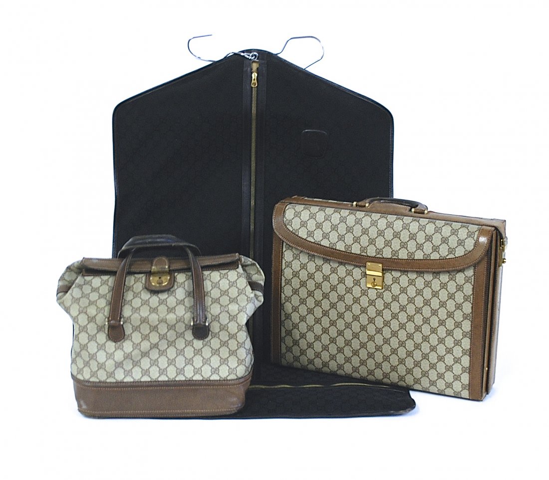 Gucci: Three assembled vintage bags consisting of garment bag, briefcase, purse. Briefcase 17 x 12.5. Collection of Tom Powell.