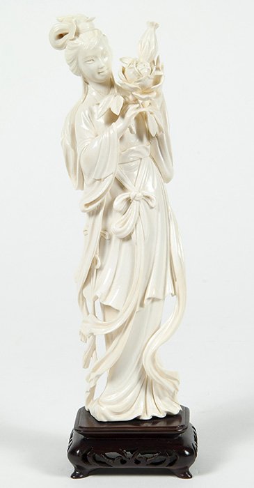 Ivory Floral Woman: Woman holding large flower petal in ornate robe. Size 10H. Collection of Tom Powell