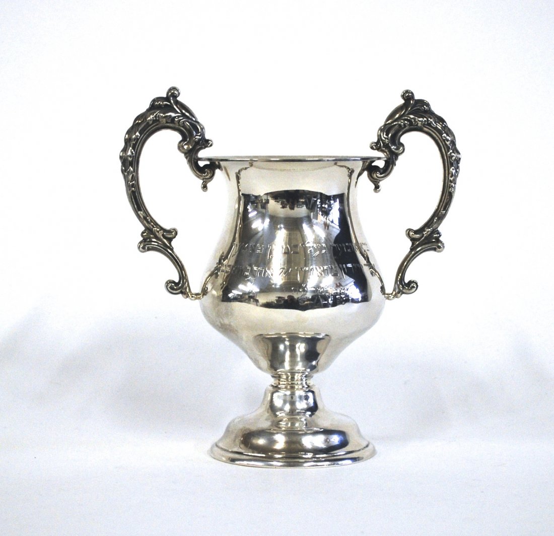Presentation Sterling Cup: Double handled Sterling Cup with ornate Acanthus leaf pattern handles. Monogrammed to both sides. Manufacturer's mark to underside, Sterling #2395. Size 7.25w x 4.25d x 8.5h. 10ozt ( with Hebrew inscr