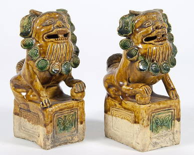 Early Chinese Foo Dogs: Earthenware with glaze. Possibly Tang Dynasty. Embossed symbol to each base. Size, 7.25H