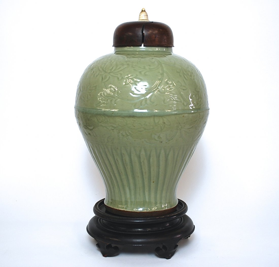 Large 17th Century Chinese Storage Jar: Covered Celadon vase with leaf pattern, wood and ivory lid, Ming Dynasty. Size, 18.25H. Stand not included. Collection of Dr. Robert Kemper.