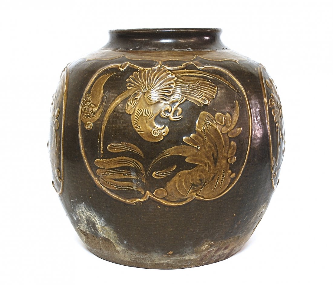 16th Century Chinese Martaban Storage Jar: Glazed stoneware with raised design of cranes, rocks and flowers. Ming or Qing Dynasty. Size, 13 diameter x 13.5H. Collection of Dr. Robert Kemper.