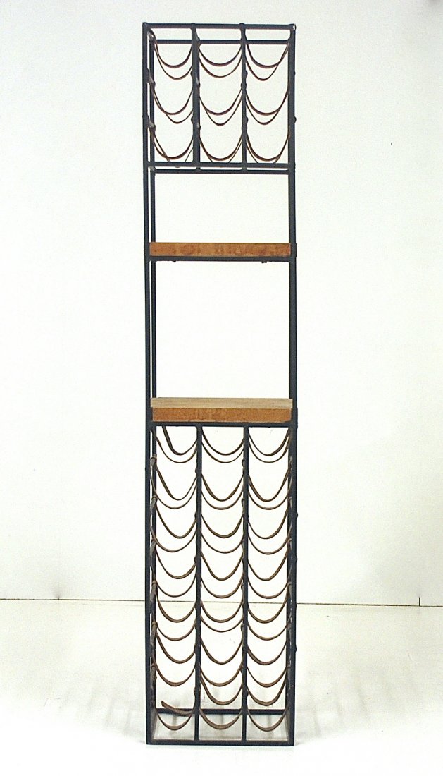 Arthur Umanoff: Forty -five bottle wine rack. Iron, leather, Birch. Size, 14W x 11D x 66.25H