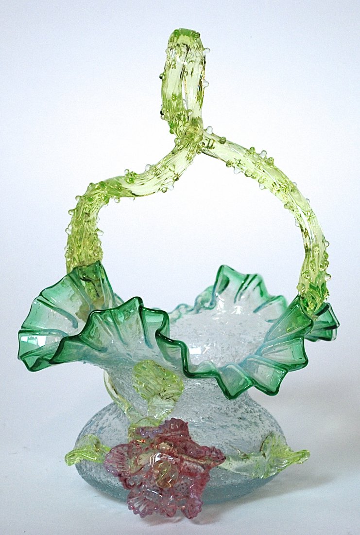 Victorian Art Glass Basket: In the manner of Stevens & Williams with overshot body, ruffled edge, applied rose and leaves and twisted thorn handle, with snap pontil base, 6.5” diameter x 9” high.