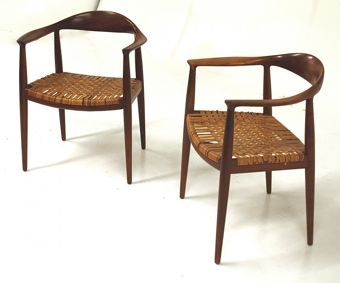 Hans Wegner: "The Chair" pair, Denmark 1949, Teak, cane. Johannes Hansen for Knoll International. Branded Manufacturers mark to each example. 25W x 21D x 30H.
