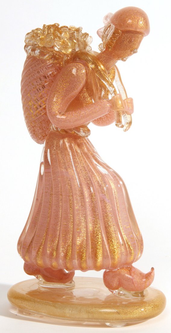 Ercole Barovier: Figure with flower basket. Barovier & Toso, Murano, Italy. Clear and pink cased glass with gold inclusions. Size 4.25w X 7d X 13h.