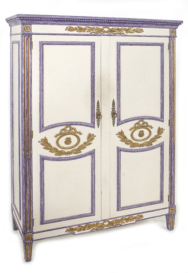 Baker Armoire: Fine two door armoire with embossed center wreaths and floral mounts. Molded border top and fluted columns with medallions resting on legs. Interior has three drawers and shelves. Baker Furniture, Pro