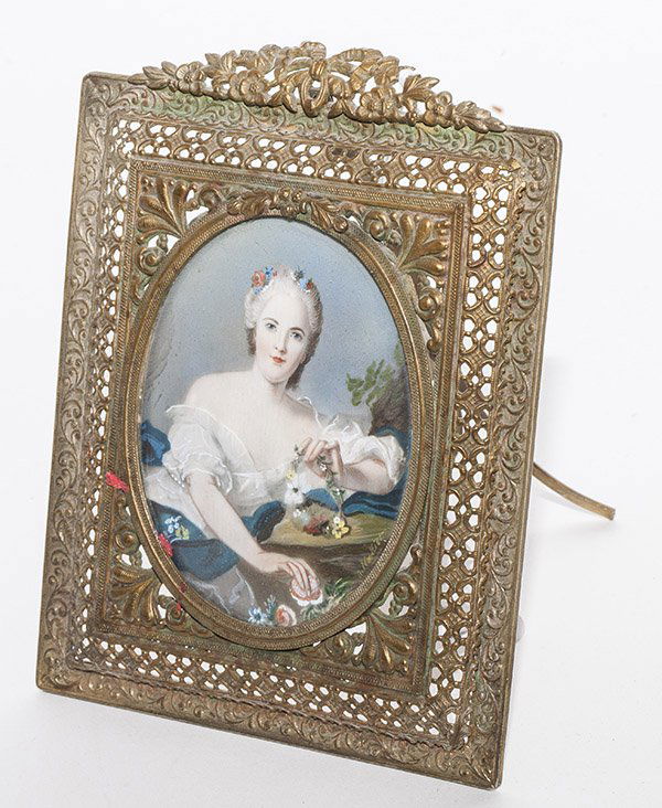 Signed Miniature on Ivory Portrait: oval portrait of a lovely young lady in powdered wig with flowers and pearls in hair, off the shoulder white satin gown with blue sash, holding wreath of flowers in left hand and picking a flower from