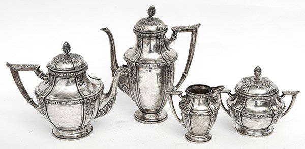 Continental Silver Coffee/Tea Service: Four piece (.800) tea set comprised of coffee pot, tea pot, creamer and sugar. Each piece has an artichoke finial and is resting on footed base. Embossed Acanthus leaf borders with berries and