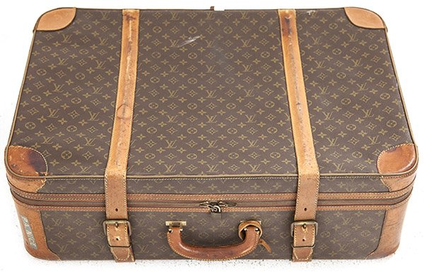Louis Vuitton suitcase: 1950's soft sided suitcase, manufacturer's marks. Vinyl , leather, brass. Size 31w x 10d x 212h