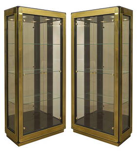 Baker Vitrines: Outstanding display cabinets, pair. Illuminated interior, fitted glass shelves, glass doors. Two Manufacturers labels, lacquered wood, brass , glass. Size 36w x 16.5d x 84h