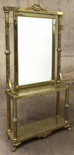 Mastercraft Attribution Hall Mirror: Fine hall tree with claw feet, simple columns, center shelf and ball finials. Beveled glass mirror, embossed shell and scrolled pediment. Four hooks, 1970's. Brass, beveled glass. Size 40w x 13d x