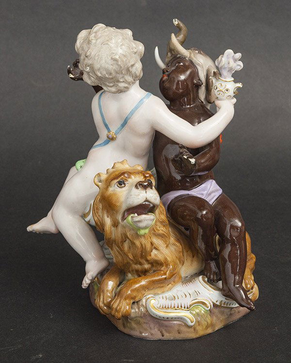 Meissen Figural Group: Two cherubs wrestiling on lion resting on footed base. Bears Cross Sword mark. Size 6.5w x 6d x 8.75h