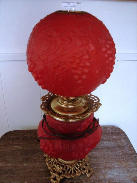 Gone With the Wind Lamp: Red glass Gone With the Wind lamp, brass base, raised floral & grape detail(minor flaking on bases), approx 23in tall
