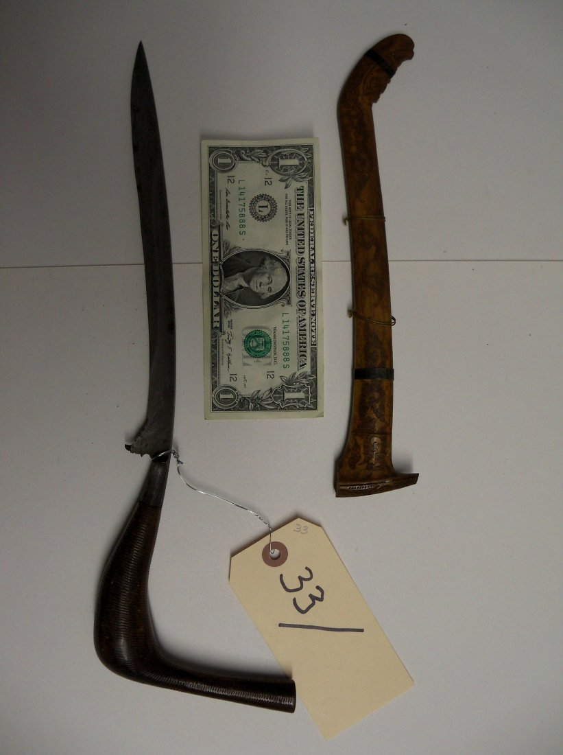 Antique 19C Indonesian Rencong or Bade Bade Dagger: This example features a finely forged blade with a double fuller and a well carved scabbard. The handle is made of a single piece of carved horn.From the William Herbert McGinty Collection. Collected 