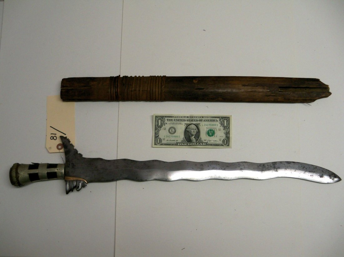 Fine large 19th Century Moro Kris Sword: The Kris is the typical Malay knife said to have originated in Java in the 14th century. Characteristic of all Kris is that the blade widens out to a sharp point next to the hilt on one side only. 21�