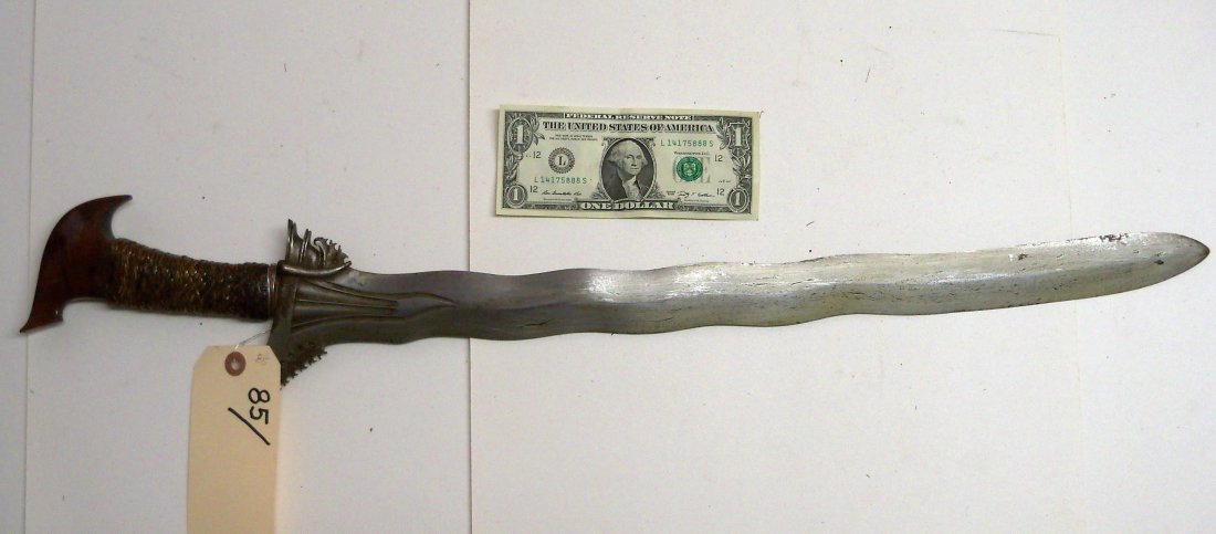 Antique 19th Century Moro Kris Sword: The Kris is the typical Malay knife said to have originated in Java in the 14th century. Characteristic of all Kris is that the blade widens out to a sharp point next to the hilt on one side only. 21�