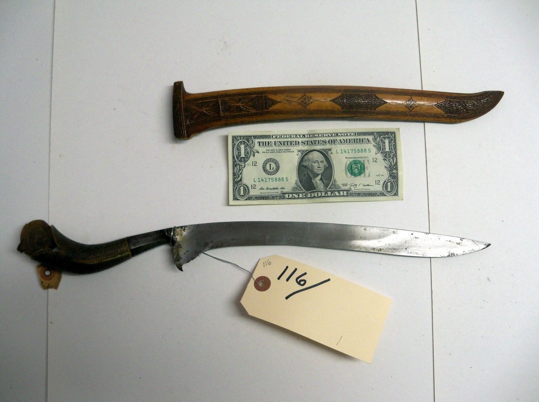 Antique 19C Indonesian Rencong or Bade Bade Dagger: This example features a finely forged 11 inch blade with a double fuller and a well carved scabbard. The handle is made of a single piece of carved horn. From the William Herbert McGinty Collection. C