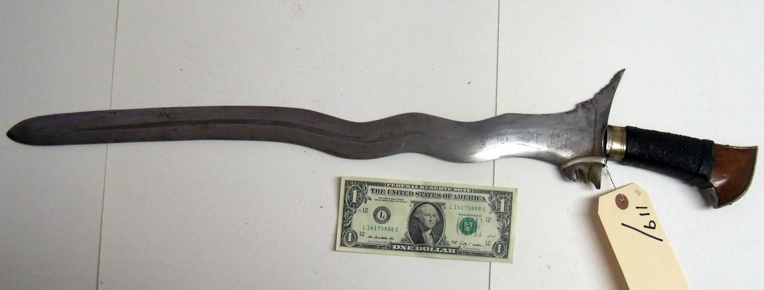 Fine Antique 19th Century Indonesian Kris Dagger or: 21¼ inch engraved blade. Grip is wrapped cord,with silver and finely grained wood.