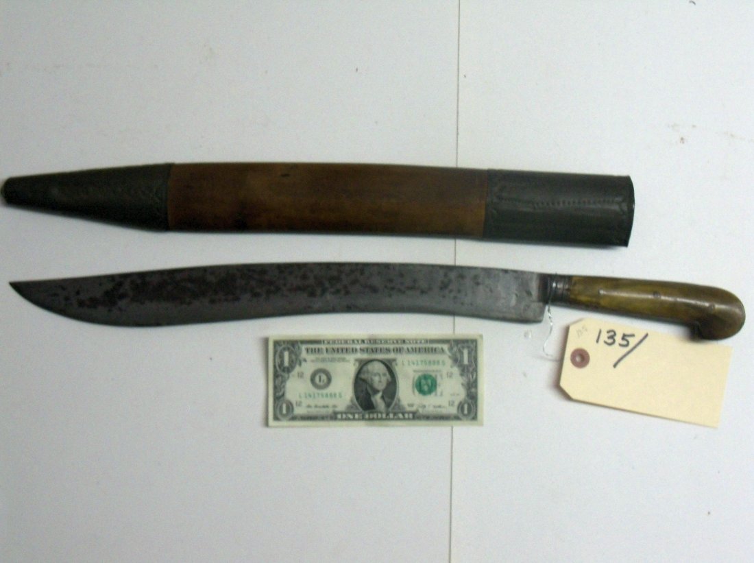 19th C. Ottoman Turkish or Balkans Yataghan Sword: Originally a Turkish weapon it was adopted throughout the Turkish Empire. Small eared horn grips, 15½ heavy blade with engraving along the top of the blade and handle. Wood scabbard with tin trim. Th