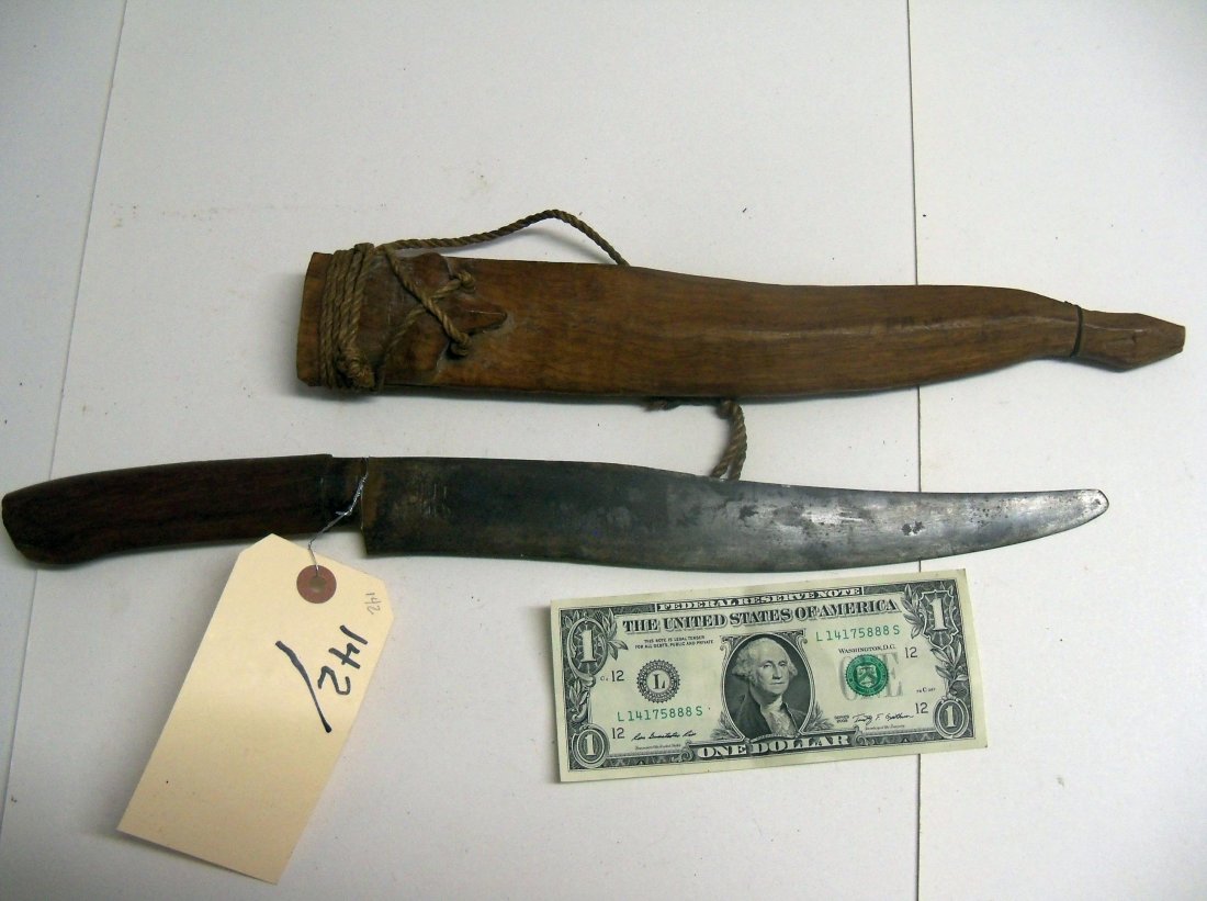 Antique Indonesian Dagger.: 11 inch blade, wood handle. Carved wood scabbard.