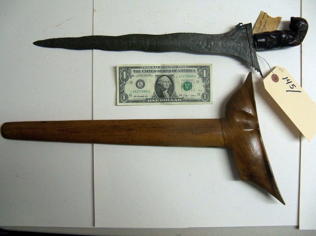 Very fine19th Century Malaysian Kris Sword Dagger: The handle is a well carved raksha or demon. It is a grotesque human figure with tusks and hair hanging down his neck in long curls. The interestingly patterned wavy blade is 14 inches long. Nicely gr