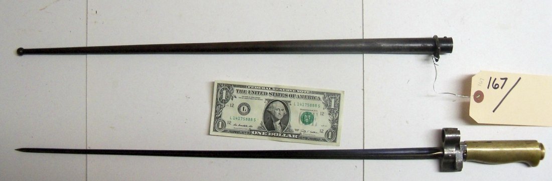 French WWI Labelle Bayonet: A version of the 1886 model. Cruciform bayonet with scabbard. The blade is 20½ inches long and the bayonet is 25¼ inches overall. Blade blueing is intact, thumb latch works, and the scabbard is free