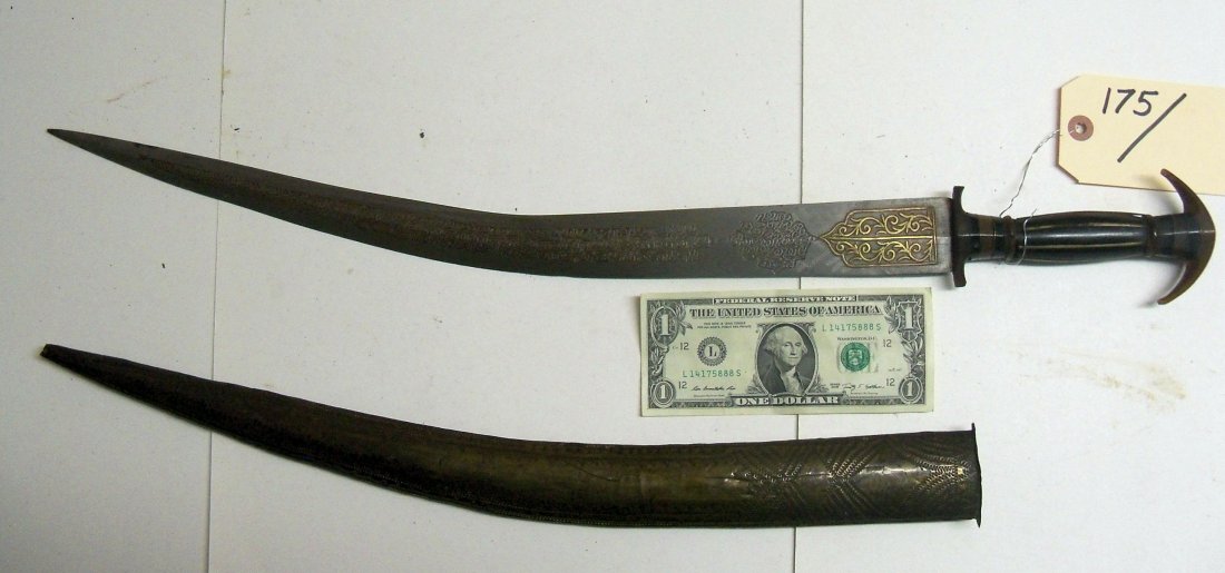 Antique 19th Century North African Khanjar Dagger: Horn and brass grip, engraved and gold inlay 20 inch blade. Brass covered wood scabbard with extensive hammered decorations. From The William Herbert McGinty Collection. Collected between the late 180