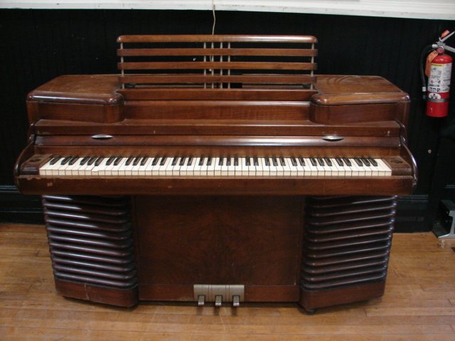 RCA Story & Clark Storytone Art Deco Electric Piano: 39" x 58" x 25" , veneer damage, not sure if it plays.Made in 1939 for NY World's Fair by Story & Clark and RCA. Customer MUST arrange own shipping.