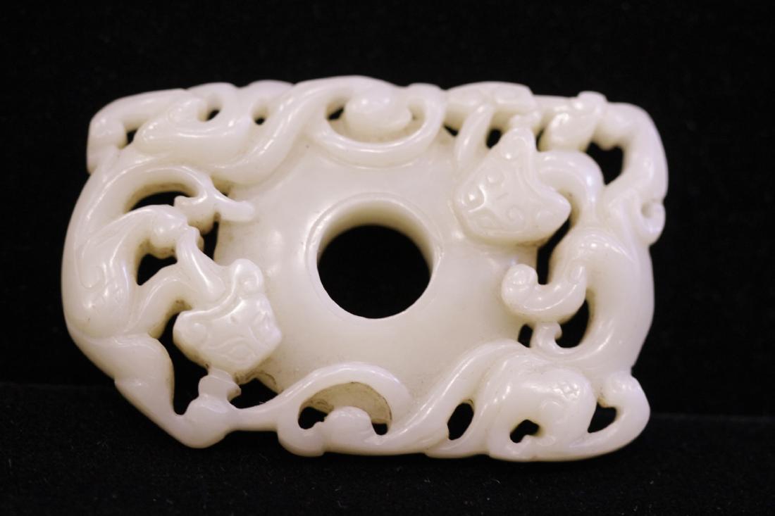 A FINELY CARVED WHITE JADE TWO-CHI DRAGON DISC, BI (1 of 7)