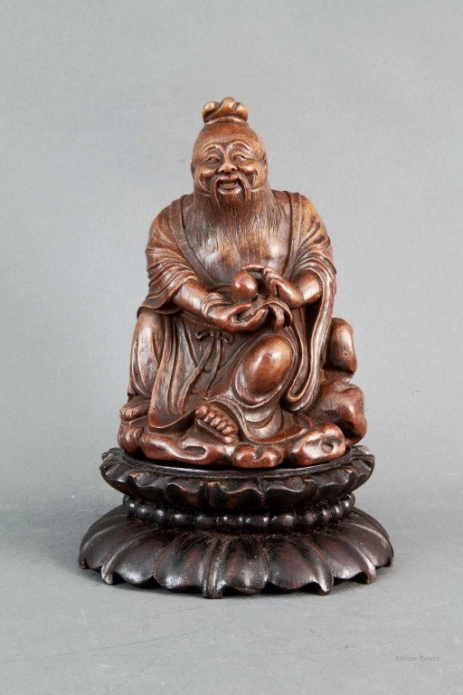 Bamboo Carved Seated Lao Shou Xing: Bamboo carved seated Shou Lao holding peach with double lotus base Condition: Available Upon Request Dimension:5 1/2"L x 4 1/2"W x 7 3/4"H