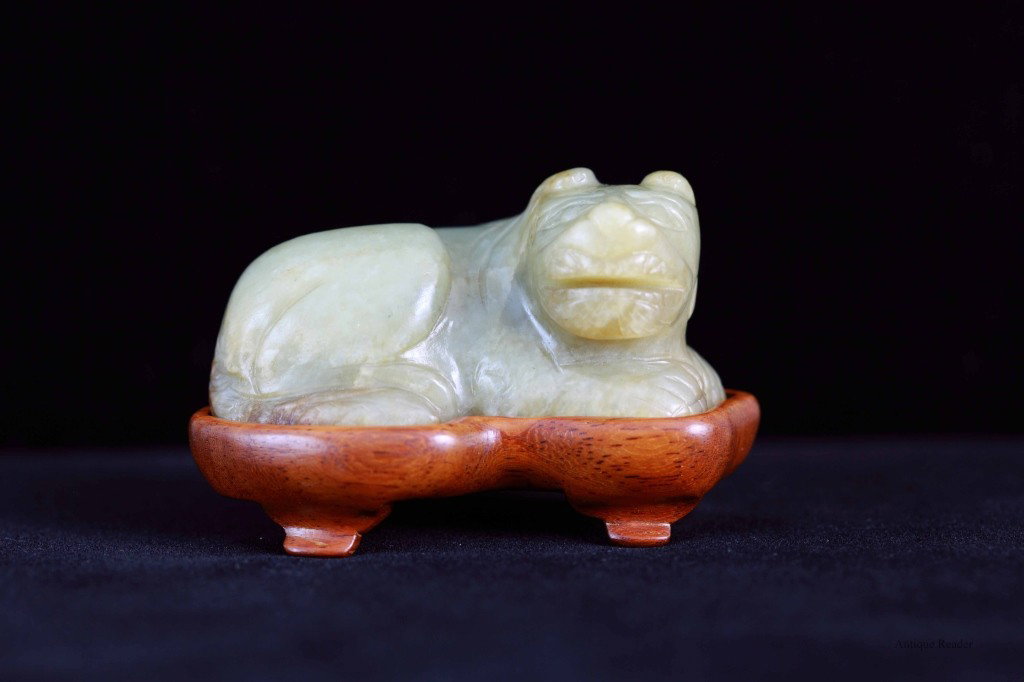 Chinese Celadon Jade Carved Foo Lion: Chinese celadon jade carved foo lion with wood base (Jin Sinan Wu) Condition: Available upon request Dimension: 3"L x 1 3/4"H x 1 3/4"W (w/ stand), 2 1/2"L x 1 1/2"W x 1 1/4"H (w/o stand)