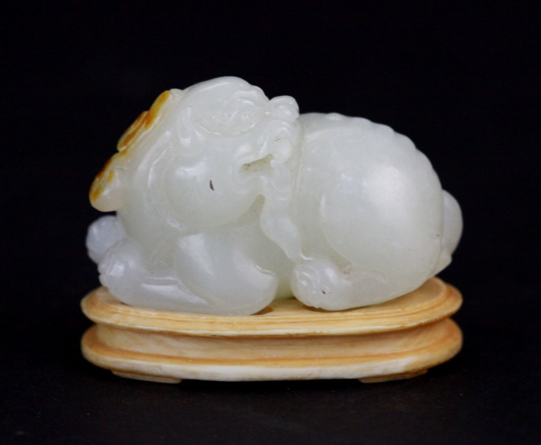 Chinese White Jade Carved Buddhist Lion: Chinese white jade carved Buddhist lion with some russet Dimension: 2"L x 1"W x 1 1/2"H (with stand)