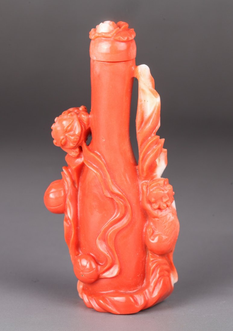 19th Century Chinese Coral Snuff Bottle: Carved with four Foo- lions play with balls surrounding the base Dimension: 3 1/8"H