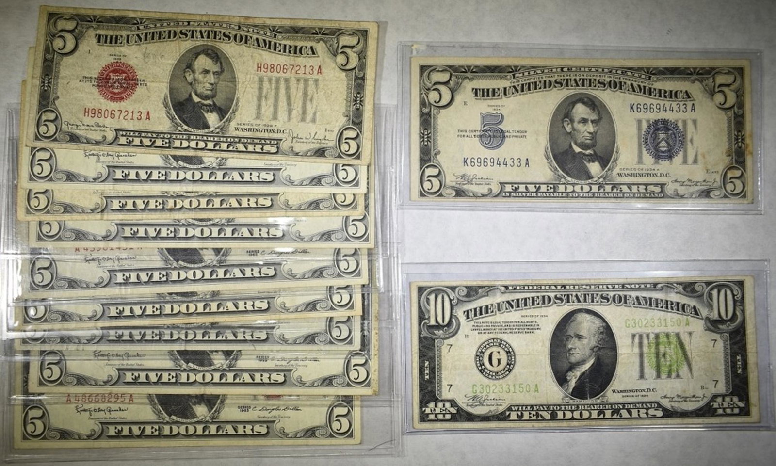 CURRENCY LOT:: 9 - $5 RED SEAL NOTES, 1 - $5 SILVER CERTIFICATE AND $10 FEDERAL RESERVE NOTE. ESTIMATE $90 - $110.