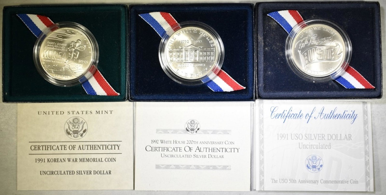 SILVER DOLLAR COMMEMS; 1991 KOREAN WAR,: 1992 WHITE HOUSE, AND 1991 USO ESTIMATE $70 - $80.
