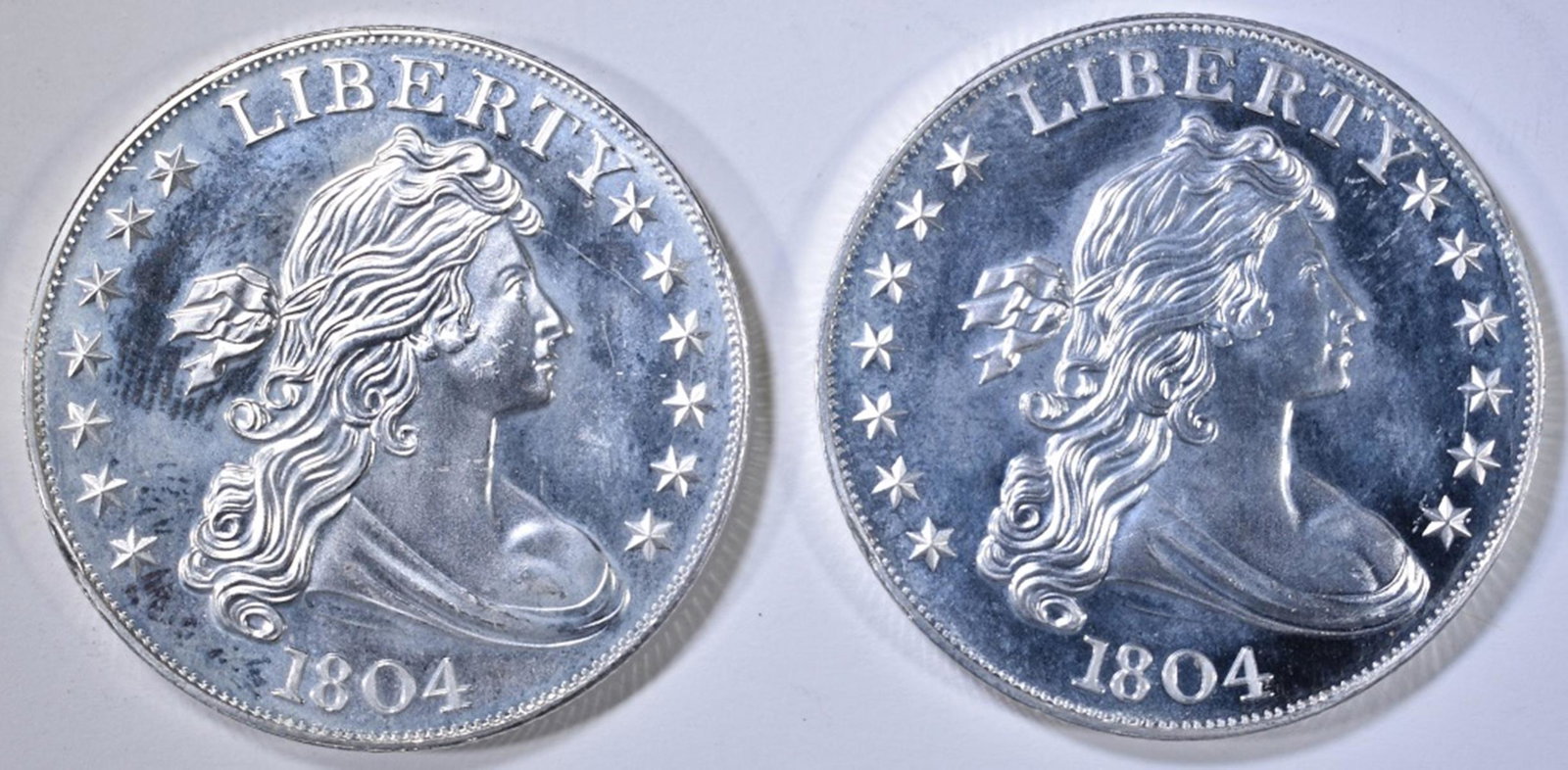 2-1804 DOLLAR REPLICA ONE OUNCE SILVER ROUNDS: BID WITH SILVER CITY AUCTIONS ESTIMATE $80 - $90.