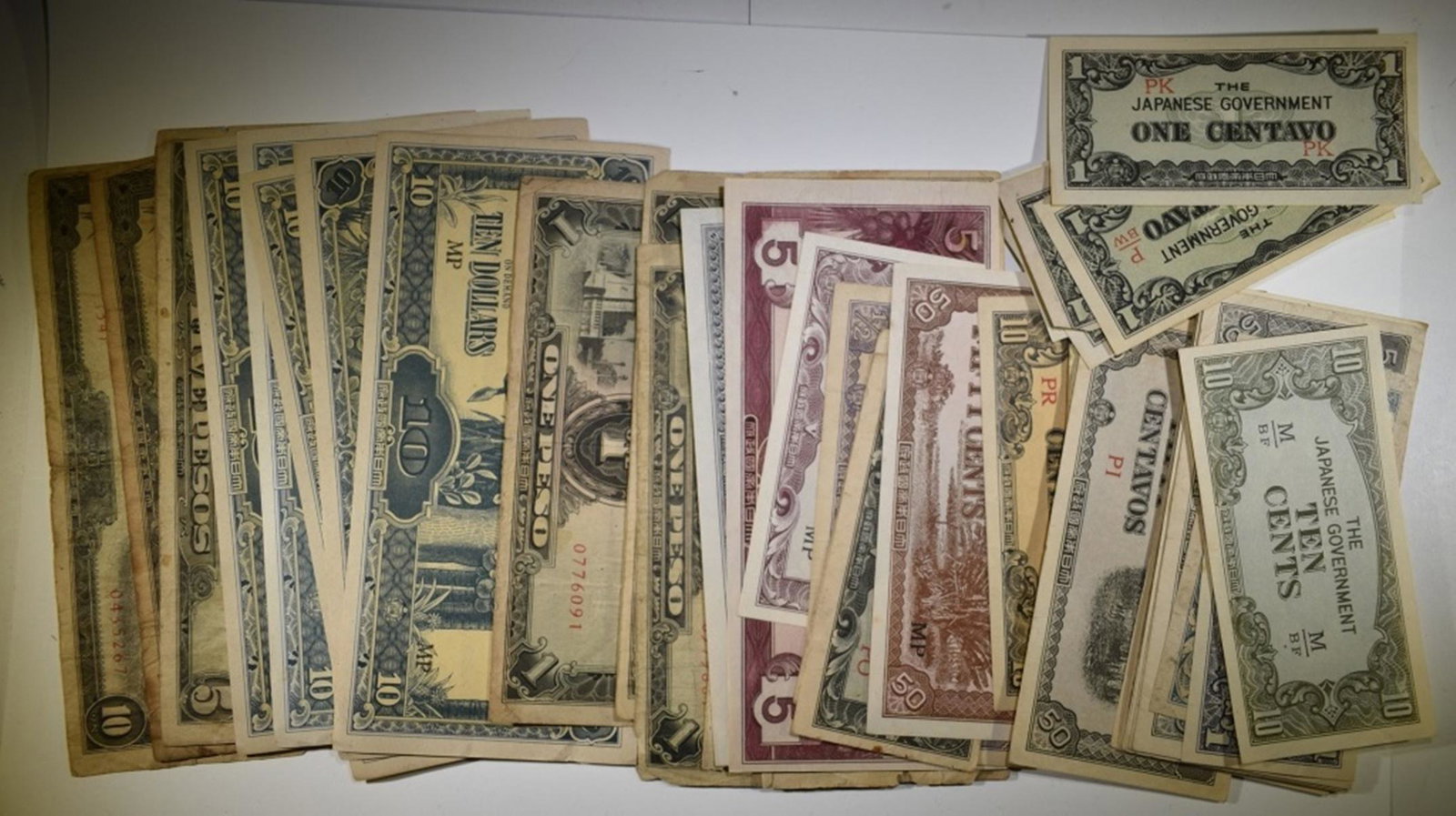 LOT OF MIXED JAPANESE GOV. OCCUPATIONAL NOTES: INCLUDES, PESOS, CENTAVOS, CENTS, DOLLARS AND MORE SEE PCITURES ESTIMATE $100 - $125.