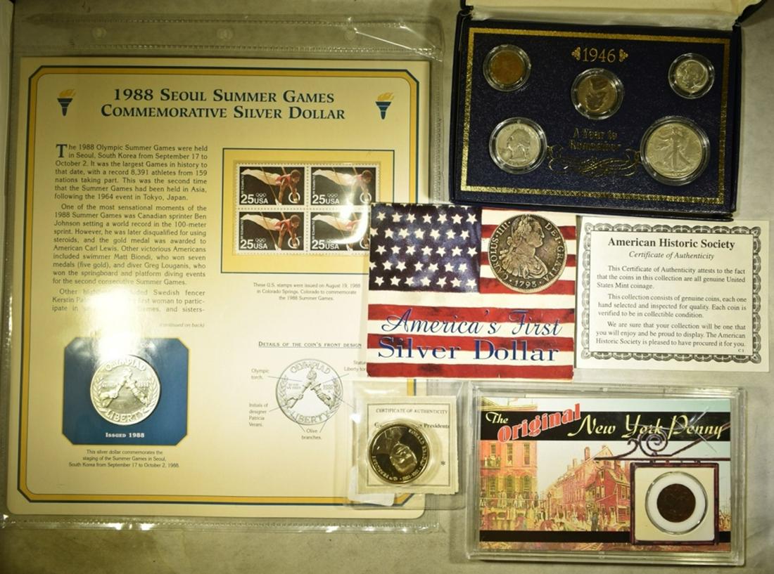 COLLECOTS LOT:: 1988 SEOUL OLYMPIC SILVER DOLLAR & STAMPS, 1946 YEAR TO REMEMBER SET, 1747 ORIGINAL NEW YORK PENNY, AMERICA'S FIRST SILVER DOLLAR REPLICA & RONALD REAGAN MEDAL. ESTIMATE $80 - $100.