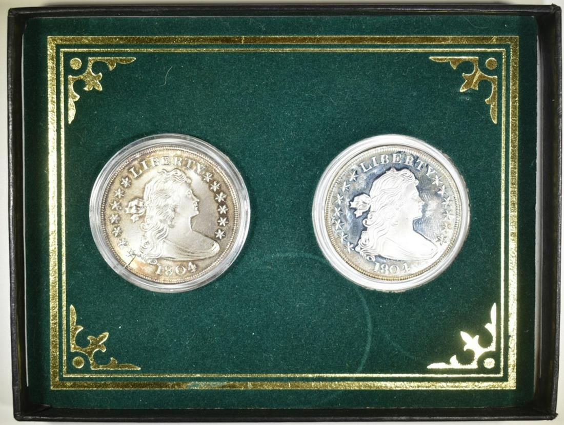 SET OF 2 1804 BUST SILVER DOLLAR REPLICAS: FROM GALLERY MINT MUSEUM, MARKED COPY. ESTIMATE $75 - $100.