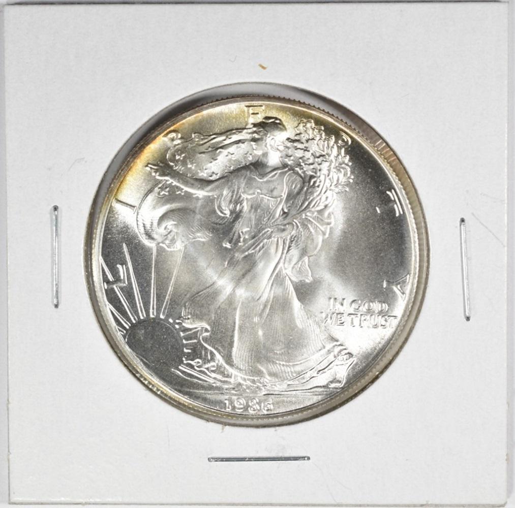 1986 AMERICAN SILVER EAGLE BU: TOP RATED AUCTION HOUSE ESTIMATE $80 - $120.