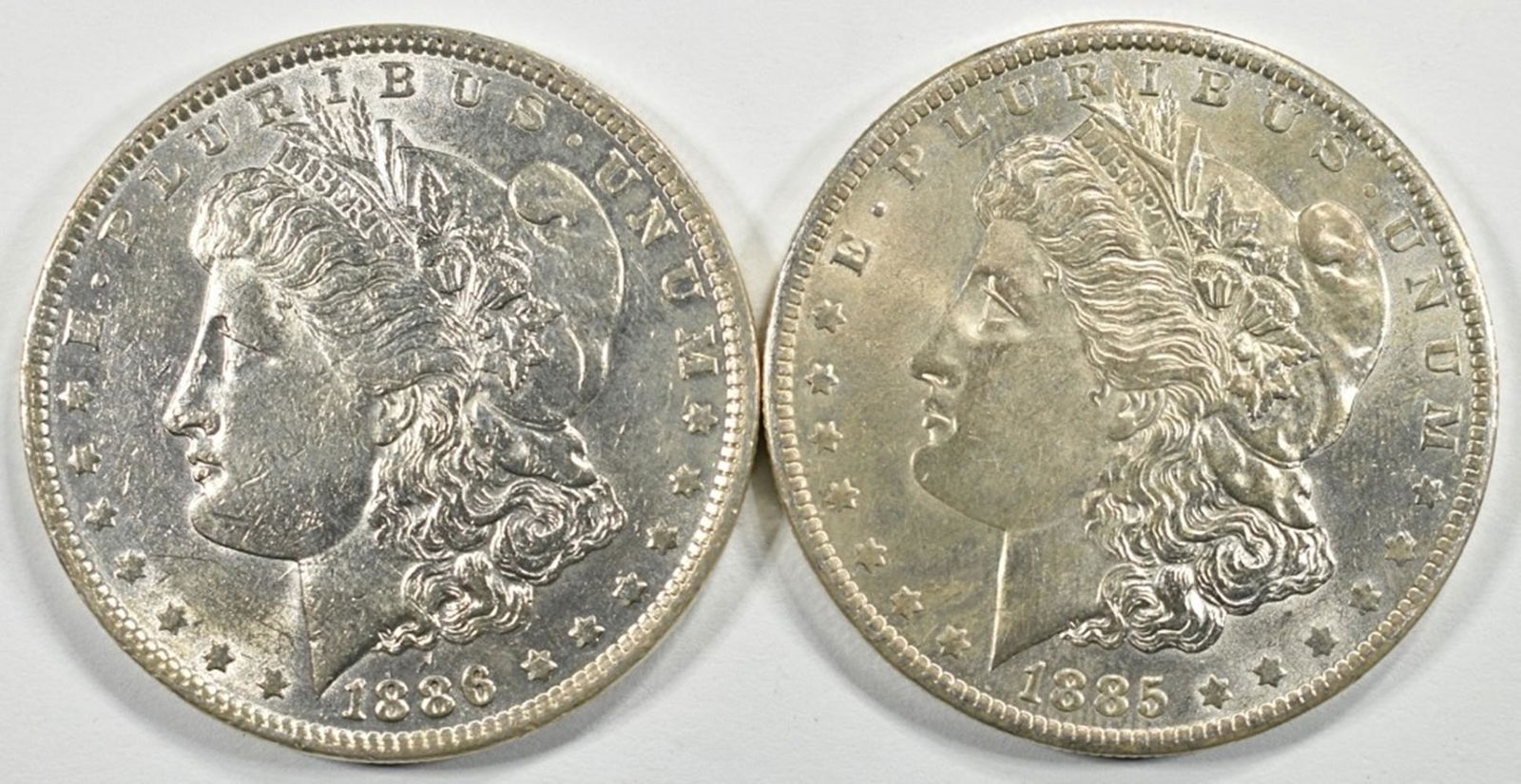 1885-O,86 MORGAN DOLLARS AU/BU: TOP RATED AUCTION HOUSE ESTIMATE $160 - $200.