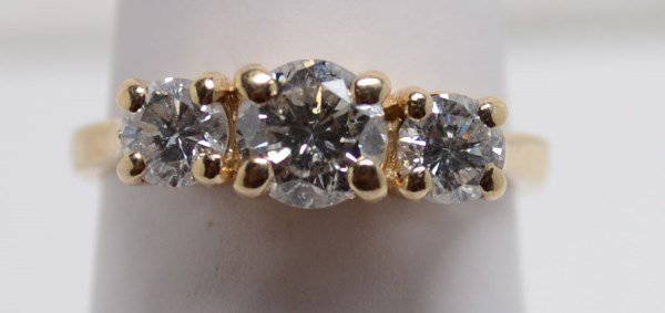 14kt Diamond Ring. 1.50 ctw size 6.: 14kt Diamond Ring. 1.50 ctw size 6. Center .81 I2 clarity J-K color. approx. I1 H color. 2.6 dwt.