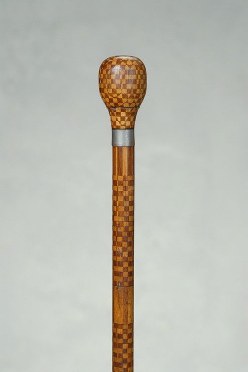 A very nice marquetry cane with small wood inlays: A very nice marquetry cane with small wood inlays. The two-piece wood knob handle is 1 3/4' high and 1 1/8" at its widest. It is fully inlaid with small bits of light and darker wood in a checkerboard