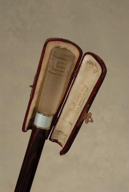 A lovely Art Deco rock crystal and enamel cane: A lovely Art Deco rock crystal and enamel German cane with a protective case. The rock crystal cylindrical handle is 3 1/4" high and 3/4" across the top. It is mostly frosted with a textured surface. 
